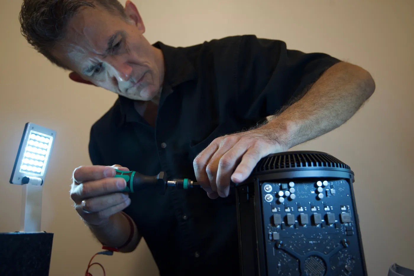 Leo, GatorTec's senior technician, working on a Mac at the repair bench